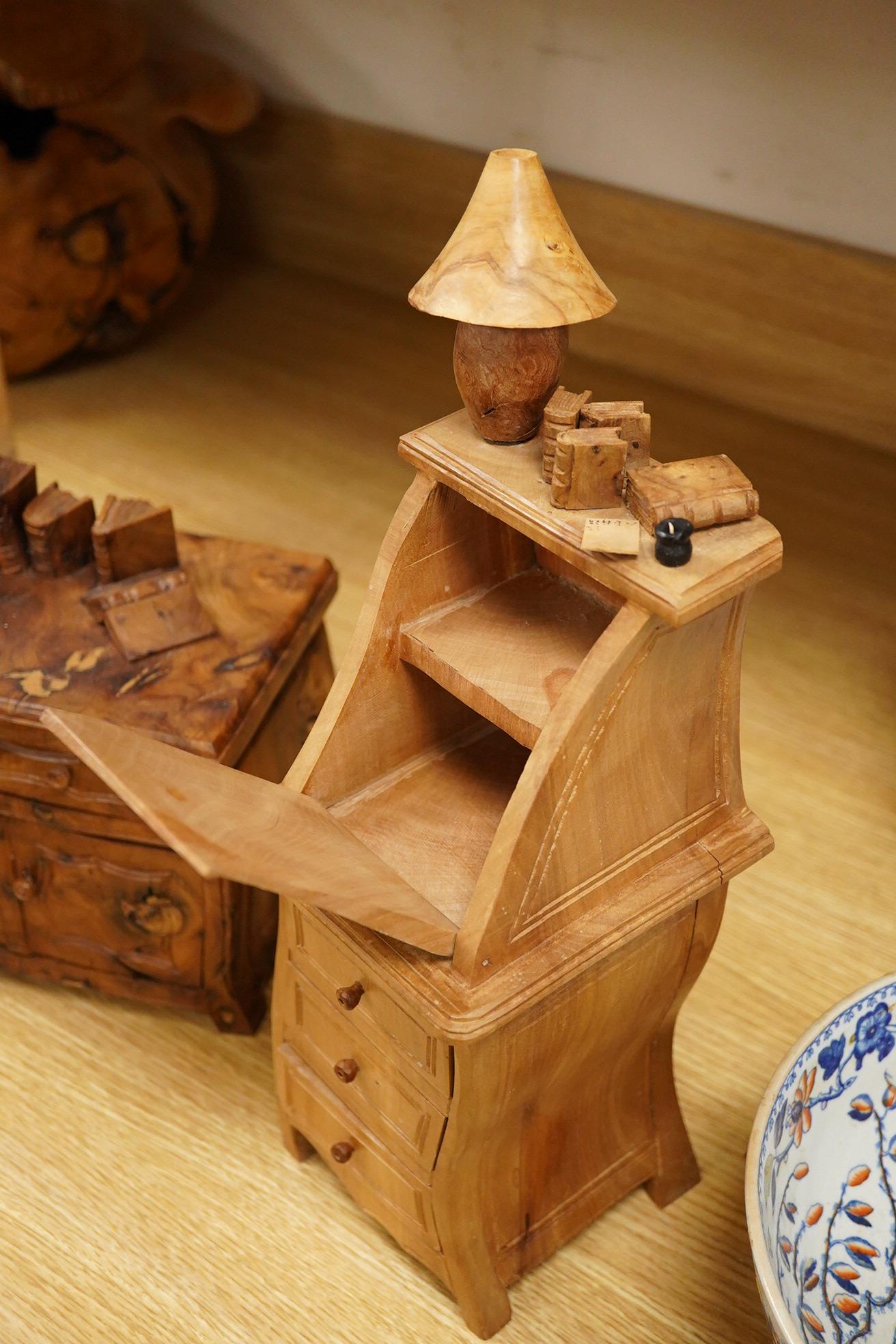 Two Piere Decorse (b.1953), a naturalistically modelled sculpture of a miniature carved novelty bureau and a sideboard, both surmounted with books and a lamp, largest 39cm high